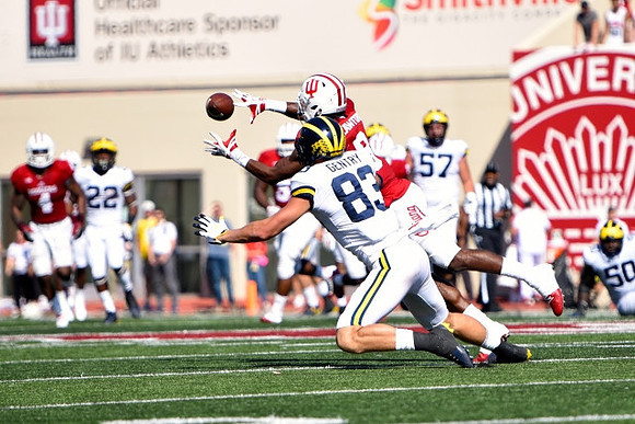Karan Higdon (22), Zach Gentry (83), Patrick Kugler (57), and Michael Onwenu (50)