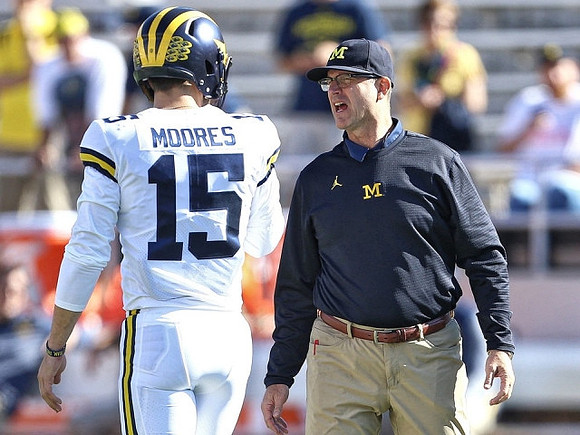 Garrett Moores (15) and Jim Harbaugh