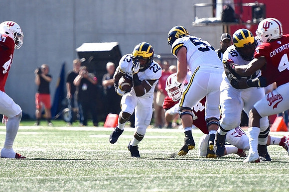 Karan Higdon (22), Mason Cole (52), and Michael Onwenu (50)