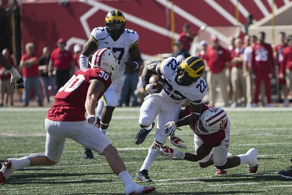 Tyrone Wheatley Jr. (17) and Karan Higdon (22)