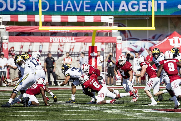Tyrone Wheatley Jr. (17), Ty Isaac (32), Ben Bredeson (74), and Michael Onwenu (50)