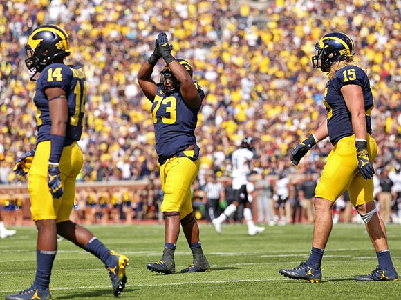 Josh Metellus (14), Maurice Hurst (73), and Chase Winovich (15)