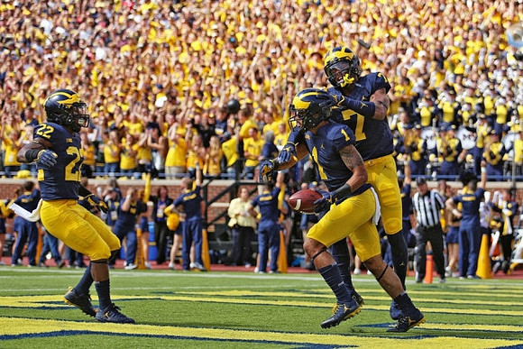 Karan Higdon (22), Kekoa Crawford (1), and Tarik Black (7)
