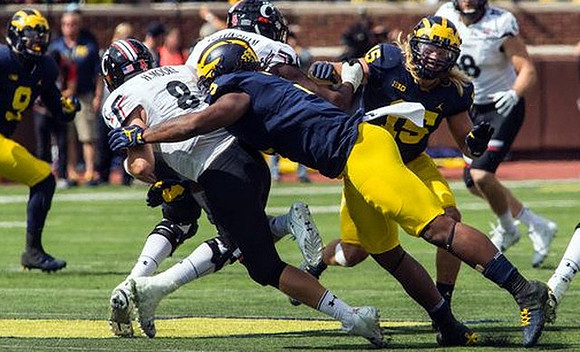 Mike McCray (9), Rashan Gary (3), and Chase Winovich (15)
