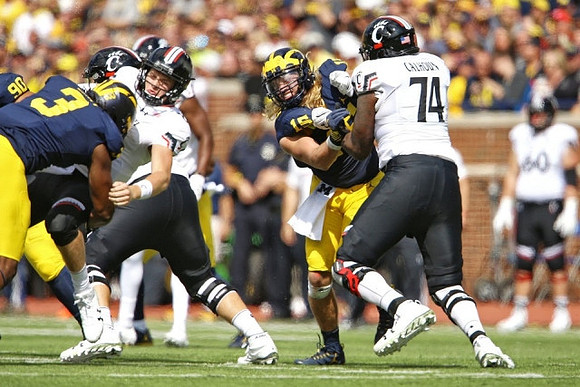 Bryan Mone (90), Rashan Gary (3), and Chase Winovich (15)
