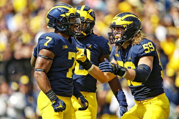 Khaleke Hudson (7) and Noah Furbush (59)