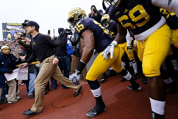 Jim Harbaugh, Jake Rudock (15), and Willie Henry (69)