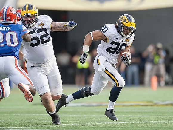 Mason Cole (52) and Drake Johnson (20)