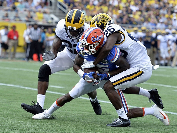 Jarrod Wilson (22) and Jourdan Lewis (26)
