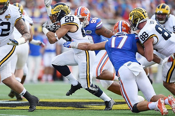Mason Cole (52), Drake Johnson (20), and Jake Butt (88)