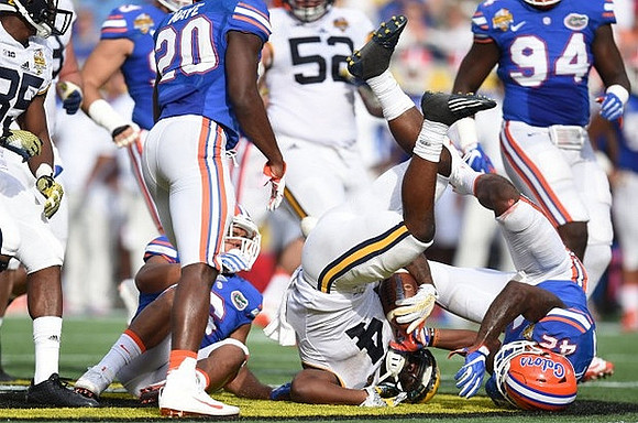Mason Cole (52) and De'Veon Smith (4)