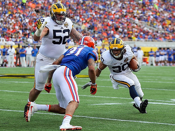 Mason Cole (52) and Drake Johnson (20)