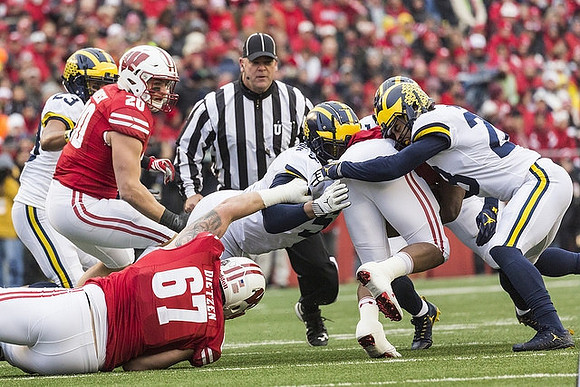 Tyree Kinnel (23), Aubrey Solomon (5), and Brandon Watson (28)