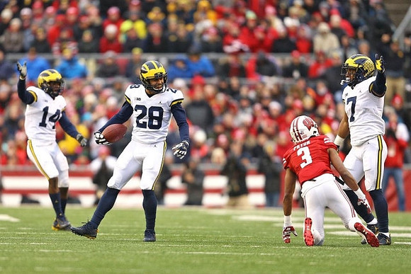 Josh Metellus (14), Brandon Watson (28), and Khaleke Hudson (7)