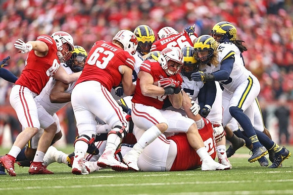 Chase Winovich (15) and Michigan Team