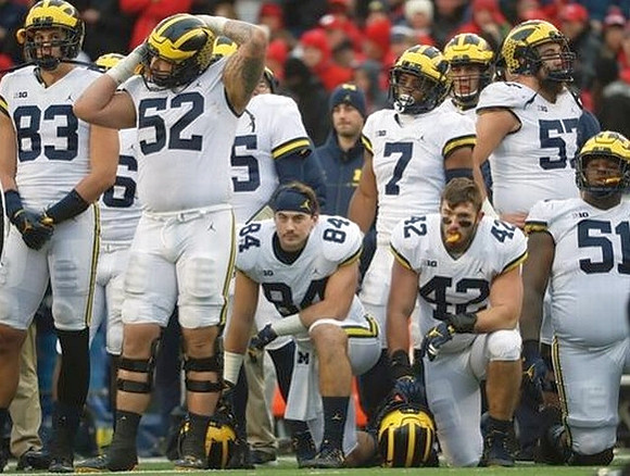 Zach Gentry (83), Mason Cole (52), Sean McKeon (84), Khaleke Hudson (7), Ben Mason (42), and Patrick Kugler (57)