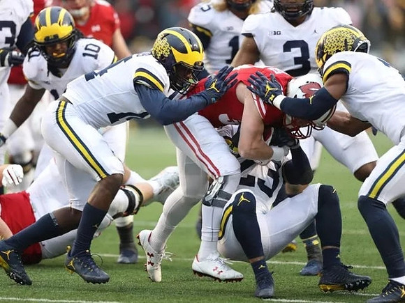 Devin Bush (10), Josh Metellus (14), Tyree Kinnel (23), Chase Winovich (15), and Rashan Gary (3)