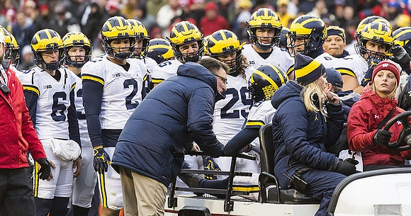 Brandon Peters (18) and Michigan Team