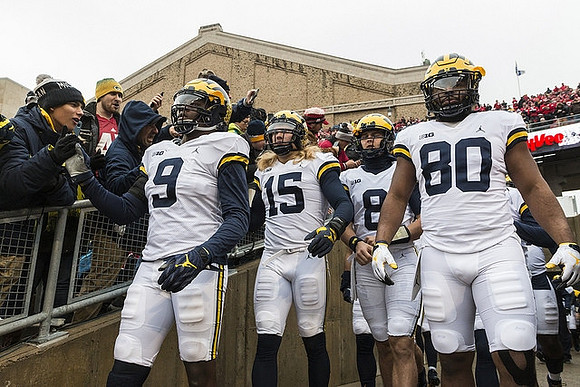 Mike McCray (9), Chase Winovich (15), John O'Korn (8), and Khalid Hill (80)