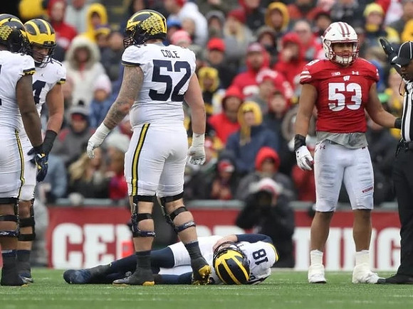 Mason Cole (52) and Brandon Peters (18)
