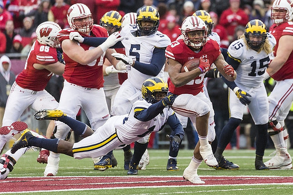 Aubrey Solomon (5), Josh Metellus (14), and Chase Winovich (15)
