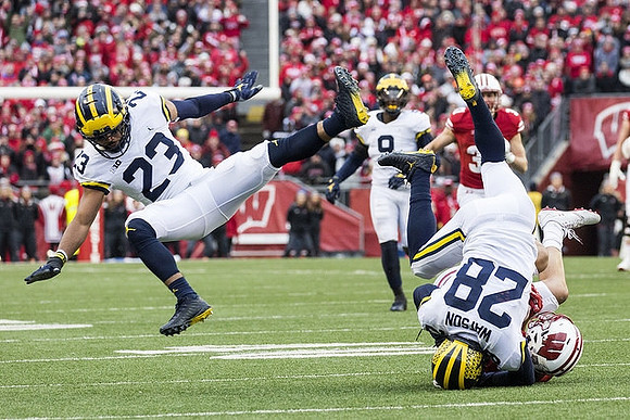 Tyree Kinnel (23), Mike McCray (9), and Brandon Watson (28)