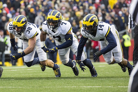 Jared Wangler (38), Khaleke Hudson (7), and Josh Metellus (14)