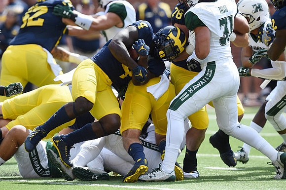 Mason Cole (52), De'Veon Smith (4), and Erik Magnuson (78)