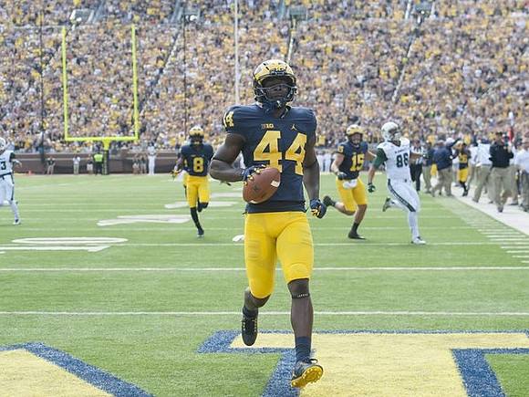 Delano Hill (44), Channing Stribling (8), and Chase Winovich (15)