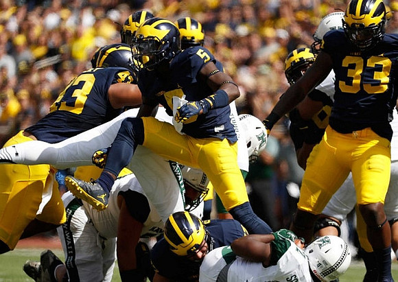 Chris Wormley (43), Jabrill Peppers (5), and Taco Charlton (33)