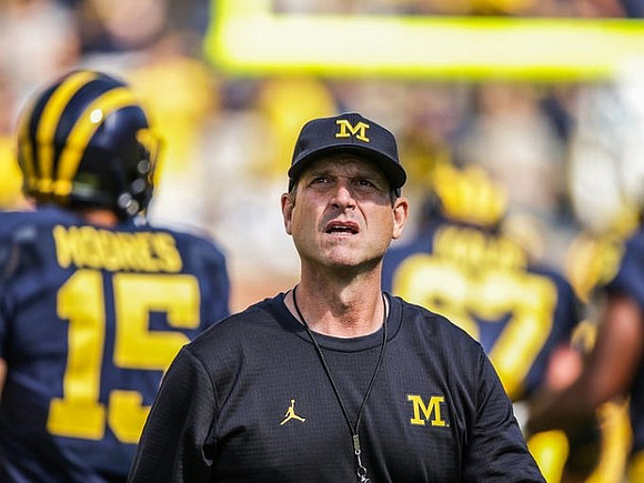 Garrett Moores (15) and Jim Harbaugh