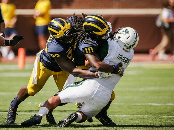 Lawrence Marshall (93) and Devin Bush (10)