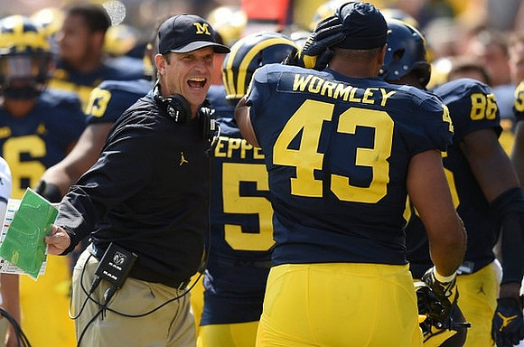 Jim Harbaugh, Jabrill Peppers (5), and Chris Wormley (43)