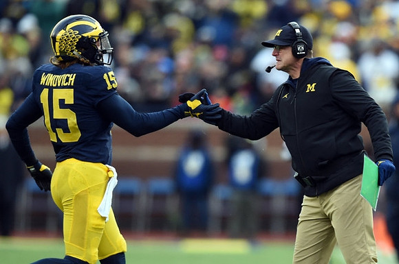 Chase Winovich (15) and Jim Harbaugh