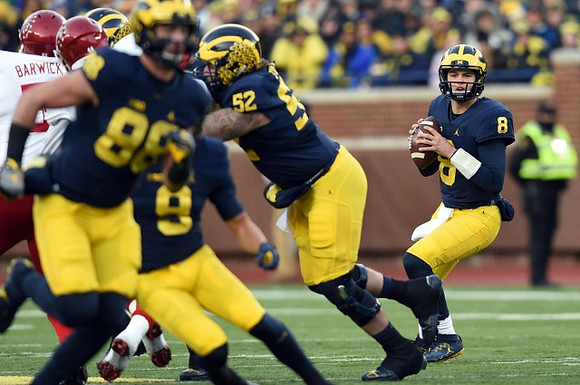 Jake Butt (88), Grant Perry (9), Mason Cole (52), and John O'Korn (8)
