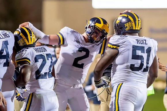 Nico Collins (4), Karan Higdon (22), Shea Patterson (2), and Cesar Ruiz (51)
