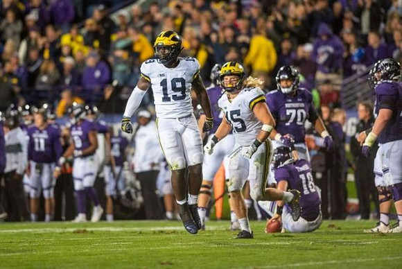 Kwity Paye (19) and Chase Winovich (15)