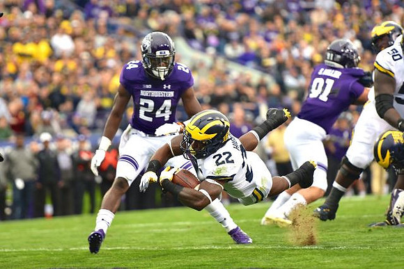 Karan Higdon (22) and Michael Onwenu (50)