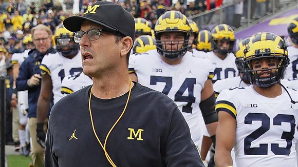 Jim Harbaugh, Ben Bredeson (74), and Tyree Kinnel (23)