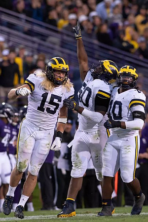 Chase Winovich (15), Michael Dwumfour (50), and Devin Bush (10)