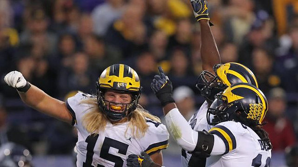 Chase Winovich (15), Michael Dwumfour (50), and Devin Bush (10)