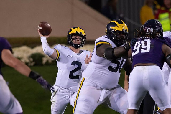 Shea Patterson (2) and Michael Onwenu (50)