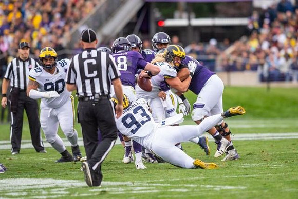 Bryan Mone (90), Lawrence Marshall (93), and Chase Winovich (15)