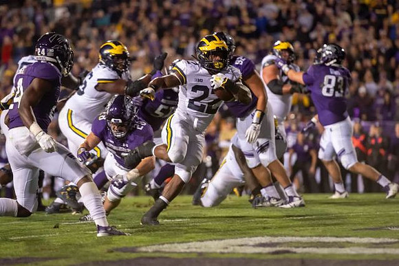 Karan Higdon (22), Juwann Bushell-Beatty (76), and Ben Bredeson (74)