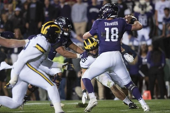 Josh Uche (6) and Chase Winovich (15)