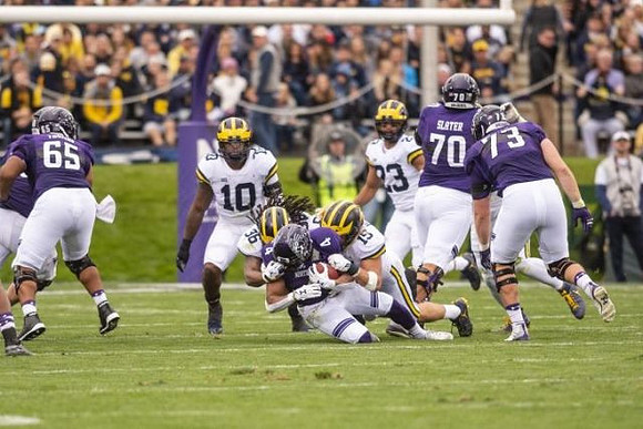 Devin Bush (10), Devin Gil (36), Chase Winovich (15), and Tyree Kinnel (23)