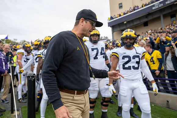 Jim Harbaugh, Ben Bredeson (74), and Tyree Kinnel (23)