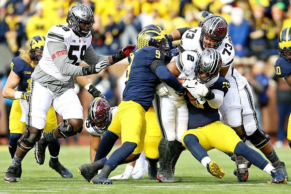 Chase Winovich (15), Mike McCray (9), Maurice Hurst (73), and Devin Bush (10)