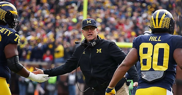 Juwann Bushell-Beatty (76), Jim Harbaugh, and Khalid Hill (80)