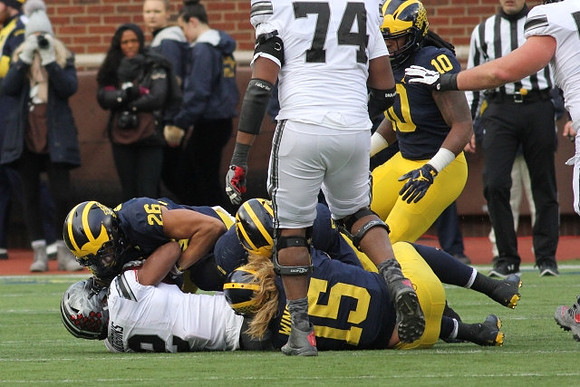 J'Marick Woods (26), Chase Winovich (15), and Devin Bush (10)